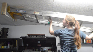 If you have a ladder that is taking up space, here is a simple project that will allow you to hang it from the ceiling